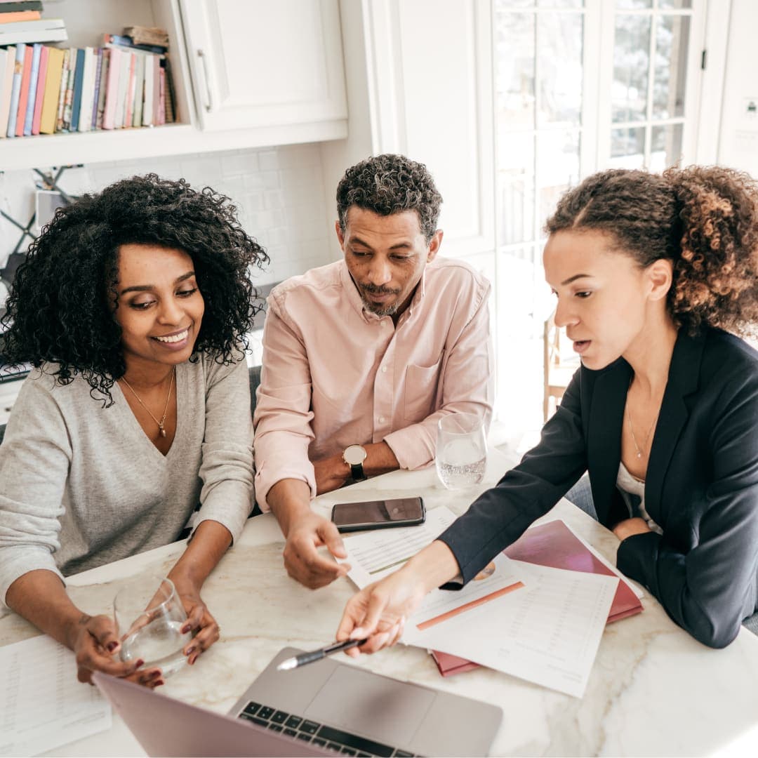 A couple reviews their household budget with a financial coach