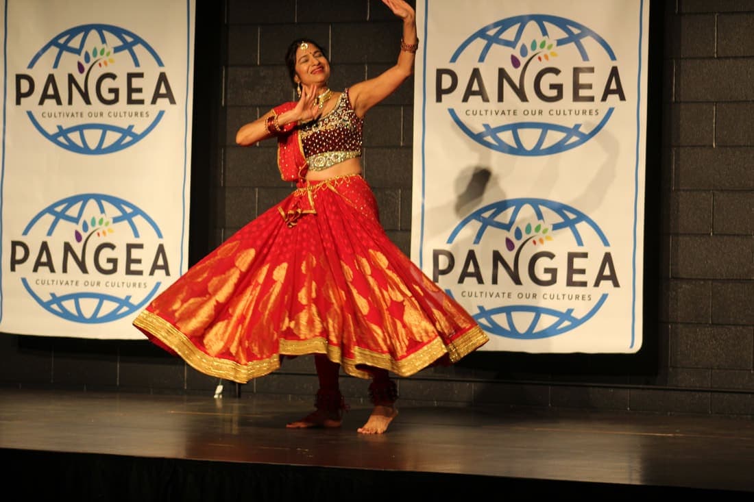 Dancer in a red and gold traditional Indian dress performing at the Pangea festival