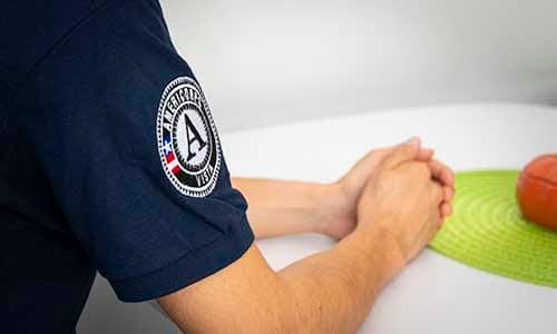 Close-up of an AmeriCorps VISTA member's sleeve patch during a meeting